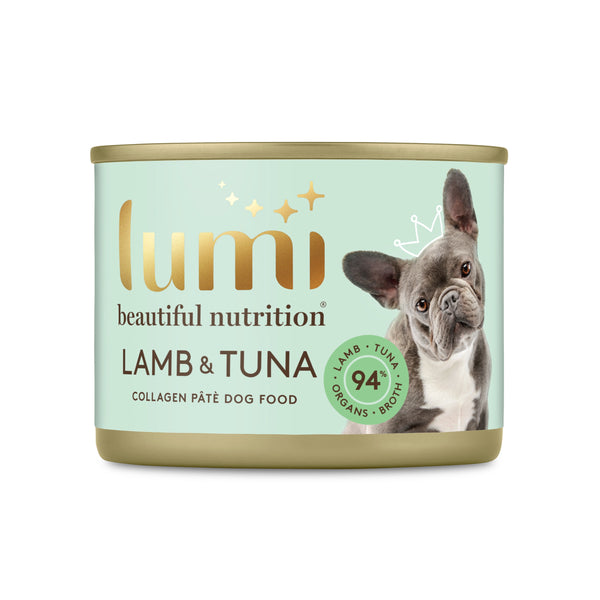 A can of Lumi Beautiful Nutrition Lamb & Tuna Collagen Pâté Dog Food on a solid white background. The can features a mint green label with gold lettering, and an illustration of a grey and white French Bulldog wearing a small gold crown. 94% Lamb, Tuna, Organs & Broth.